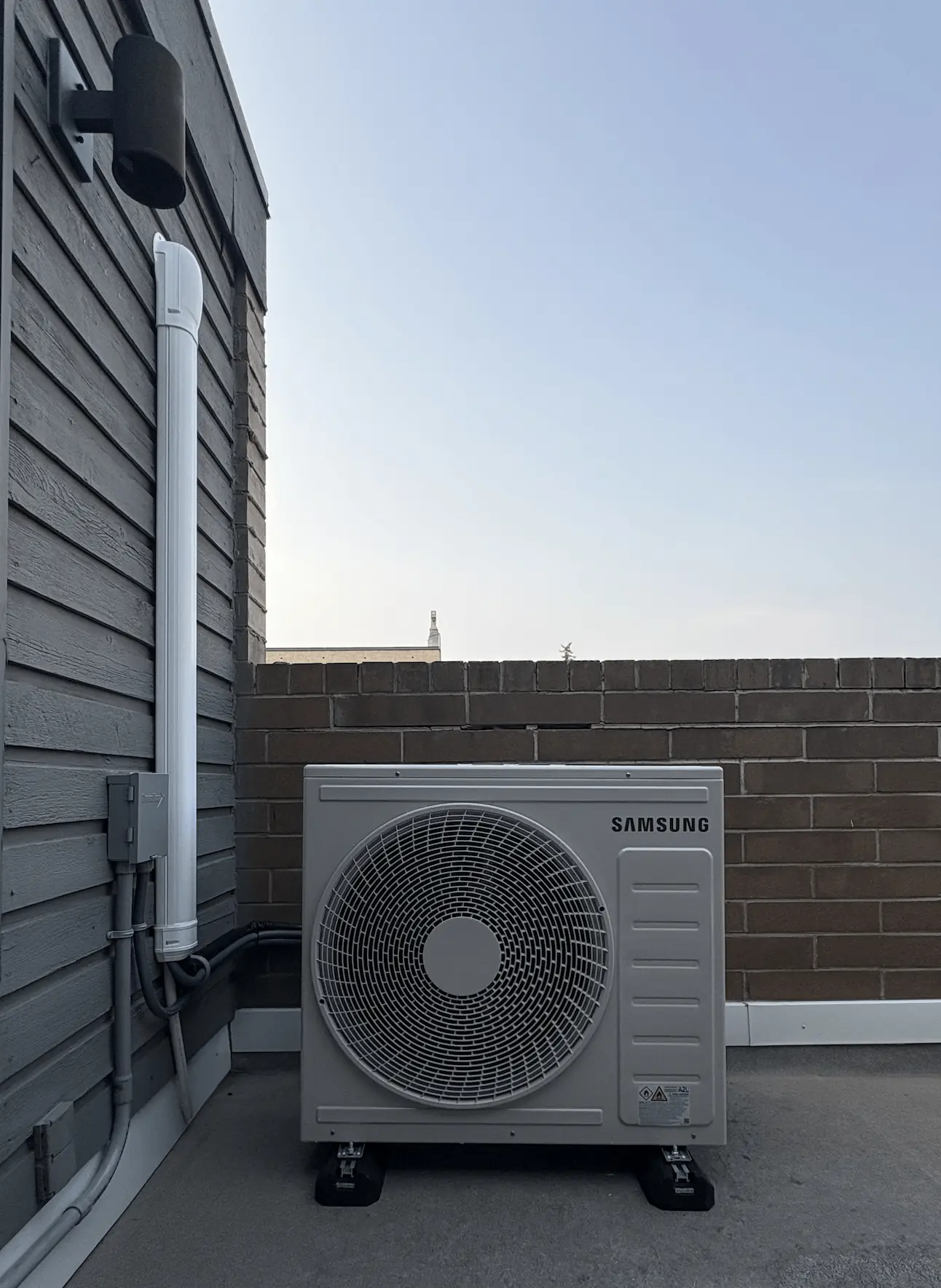 Basement HVAC system with a gray water heater tank, furnace labeled Airease, and ductwork with a GeneralAire air purifier emitting blue light.