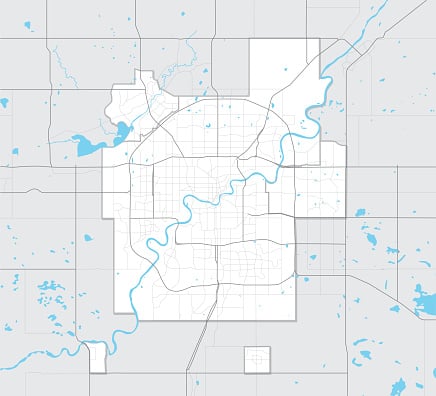 Detailed city map with streets, a winding river flowing from north to south, and scattered lakes and ponds on a gray background.