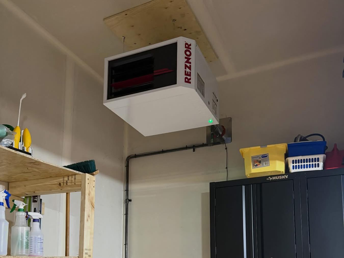 water heater tank install with pipes and ducting running in the basement