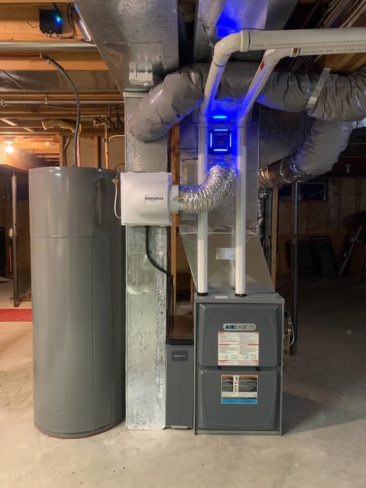 Basement utility area featuring a gray cylindrical water heater next to an Airease HVAC furnace with connected ductwork and a GeneralAire humidifier.